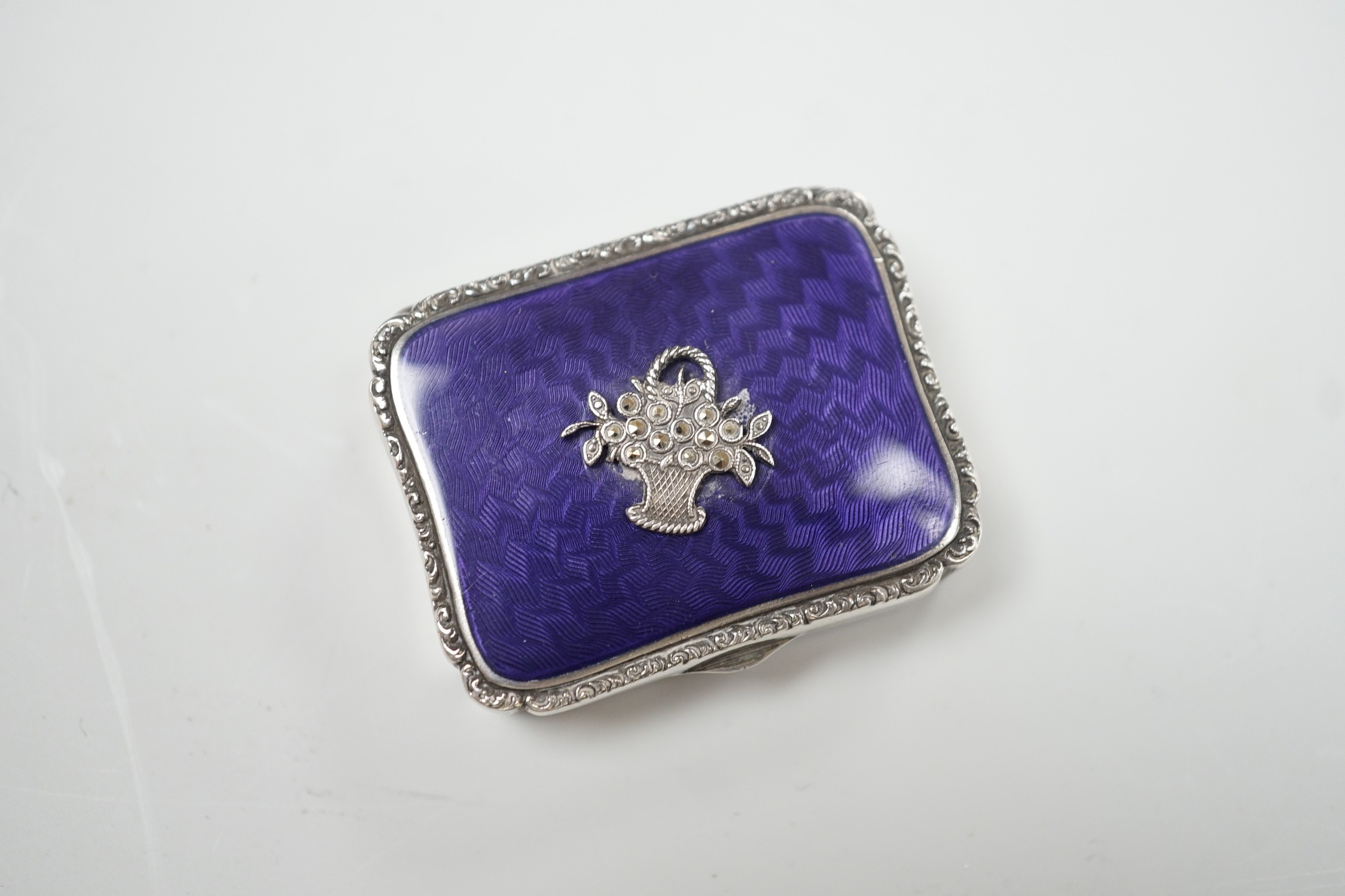 A lady's 1920's continental silver, enamel and marcasite set rouge box, import marks for London, 1925, 39mm.